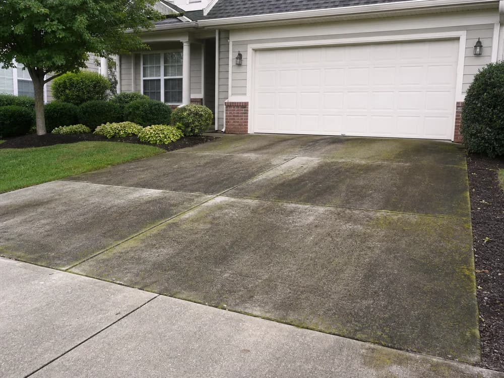 Stained driveway before professional pressure washing